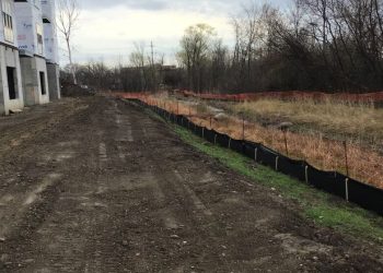 a train traveling down train tracks near a field